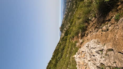 4k-Vertical-shot-of-a-long-hiking-trail-path-on-the-mountain-La-Concha,-Marbella,-Spain