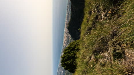 4k-Vertical-shot-of-a-beautiful-view-of-Marbella-city-and-blue-ocean-water-from-the-mountain-La-Concha,-Marbella,-Spain