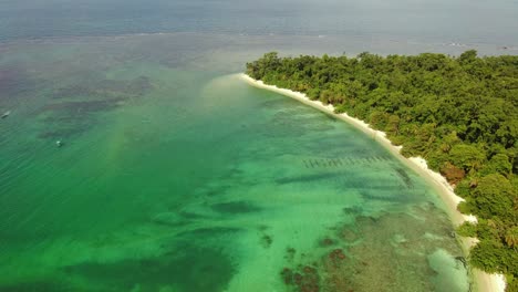 Tropical-reefs-protect-golden-beaches-and-calm-azure-waters,-Cahuita-playa,-costa-rica,-aerial