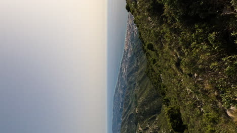 4k-Vertical-shot-of-beautiful-view-of-Marbella-by-the-ocean-coast-from-La-Concha-mountain,-Marbella,-Spain