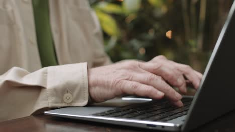 Close-up-of-hands-of-elderly-men-slowly-typing-on-the-keyboard-of-the-laptop
