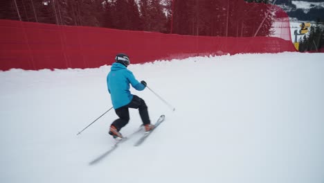 4K-of-skilled-telemark-skier-with-a-blue-jacket-going-fast-downhill-with-small-curves-on-a-cold-winter-day-in-Norway