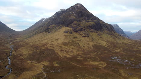Epic-Slow-moving-aerial-shot-of-the-hills-and-mountains-at-Glencoe,-Scotland-in-Great-Britain