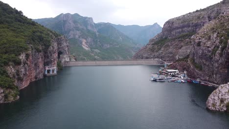 Ferry-Terminal-and-Boat-Service-at-Lake-Koman,-Albania---Aerial-Drone-View