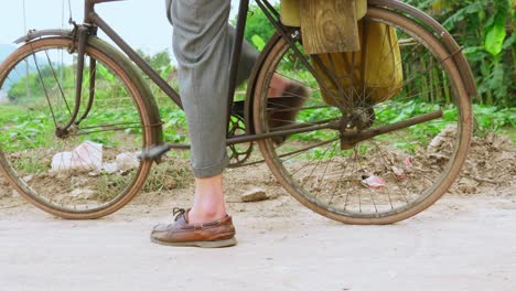 Young-man-leg-peddling-bicycle-in-the-village-at-Lang-Son-city,-Vietnam