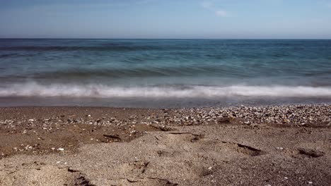Beach-waves-time-lapse-on-an-empty-pebble-beach
