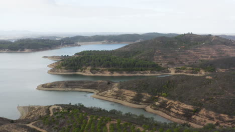Flug-Mit-Drohne-über-Ein-Großes-Wasserbecken-In-Einem-Besonderen-Geografischen-Gebiet-Im-Süden-Portugals-Namens-Santa-Clare-Lake