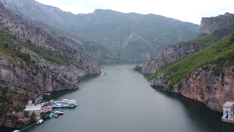 Ferry-Terminal-and-Boat-Service-at-Lake-Koman,-Albania---Aerial-View