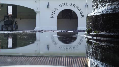 Mirror-in-the-water-of-the-main-arch-of-the-Undurraga-vineyard,-Talagante,-Chile