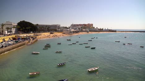 Slow-cinematic-tilt-up-over-boats-parked-in-Cadiz-harbor-at-high-tide