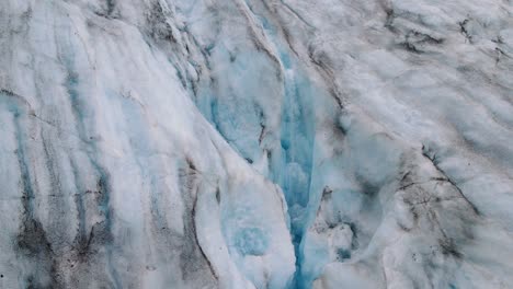 Aerial-view-of-a-stream-on-a-melting-glacier---global-warming-and-climate-change-in-progress