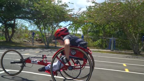 A-kid-with-disability-driving-a-handbike-at-a-paracycling-race