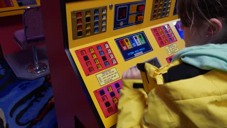 A-girl-plays-bingo-on-a-machine-in-an-amusement-arcade