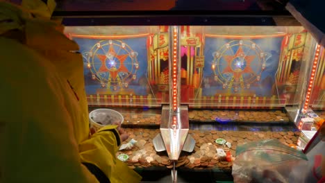 Zwei-Mädchen,-Die-In-Einem-Arcade-Casino-Auf-Einem-Münzen-Penny-Pusher-Solt-Automaten-Spielen