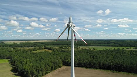 Broken-Wind-Turbines-Towering-In-Countryside-Terrain-With-Dense-Trees-In-Wiatrak,-Poland