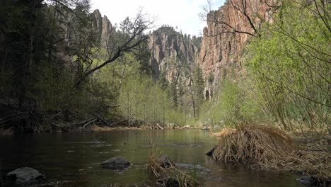 Low-angle-of-Gila-River,-New-Mexico-with-dramatic-canyon-walls-in-background