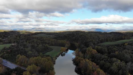 Aerial-footage-over-a-river-in-the-green-hills-of-rural-Virginia,-USA