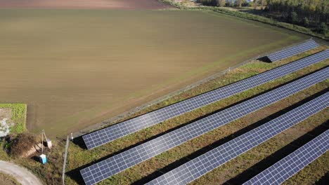Planta-De-Energía-Eléctrica-Sostenible-Con-Filas-De-Paneles-Solares-Fotovoltaicos---Toma-Aérea-De-Drones