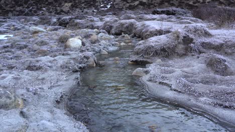 The-cold-frosty-ground-along-a-stream-in-a-valley