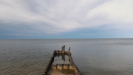 Metal-rotting-pier-in-Lake-Michigan.-Forward-push