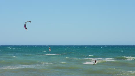 Kite-and-Wind-surfers-in-slow-motion-on-a-windy-day-with-a-clear-sky