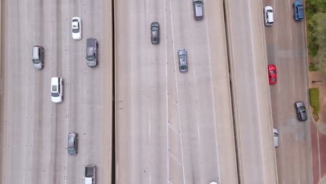 Aerial-view-over-cars-on-a-freeway,-in-Dallas,-Texas,-USA---overhead,-drone-shot