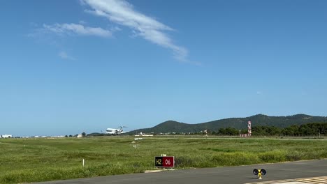 Medium-size-white-jet-landing-at-Ibiza’s-airport,-Runway-06