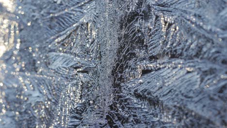 Macro-Shot-Of-Frozen-Snowflakes,-Icicles-On-A-Glass-Window
