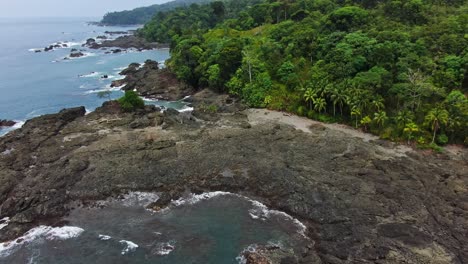 Drone-Aerial-View-Of-Tropical-Rocky-Shorefront-on-South-American-Rainforest-Coastline