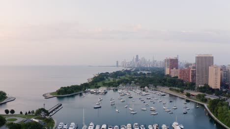 Drone-Flying-Above-Boat-Harbor-in-Chicago-with-Skyscrapers-in-Background