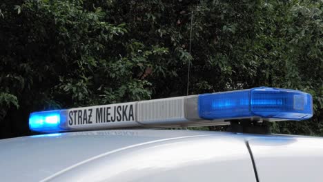 A-Blue-Flashing-Beacon-Of-Municipal-Police-Car-In-Gdansk,-Poland