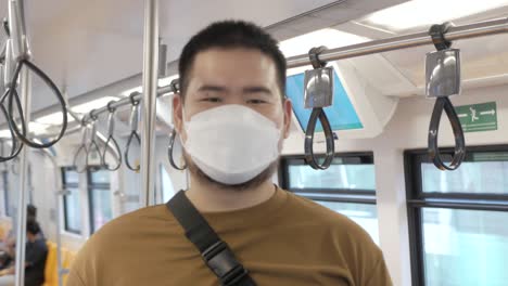 POV-to-a-man-wearing-mask-while-ridding-subway-public-transportation-in-Bangkok