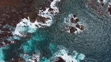 Beautiful-Turquoise-Blue-Ocean-Water-With-White-Waves-Crashing-Into-Rocky-Coast