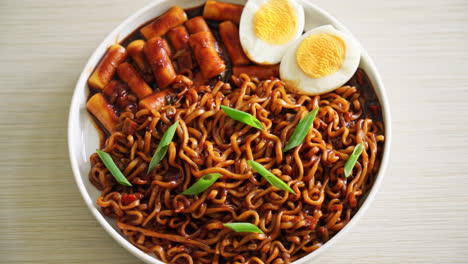 Jjajang-Rabokki---Korean-instant-noodles-or-Ramyeon-with-Korean-rice-cake-or-Tteokbokki-and-egg-in-black-bean-sauce---Korean-food-style