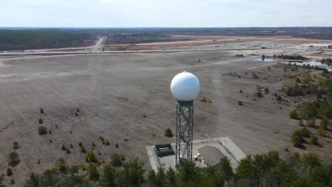 Weather-radar,-aerial-drone-shot-around-a-weather-detection-turret-next-to-a-forest