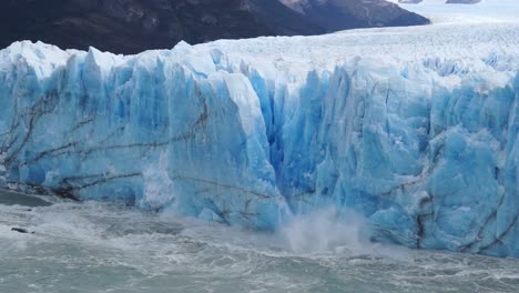 tidewater-glacier-chunk-crumbles-into-water-with-big-splash,-climate-change-and-global-warming-concept