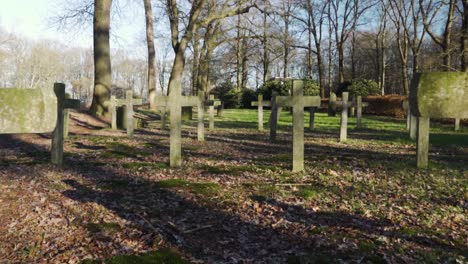 Silent-Christian-cemetery-crosses-in-the-forest,-smooth-dolly-in-shot