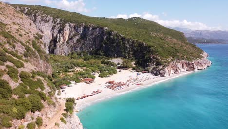 Gjipe-Beach,-Albania---Reversing-Aerial-of-White-Sandy-Beach,-Blue-Sea-and-Coastline