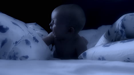 Newborn-baby-crying-loud-at-night-time-in-his-crib,-handheld-view