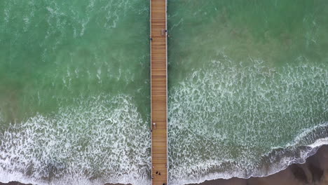birds-eye-view-drone-shot-of-a-californian-jetty-out-at-sea