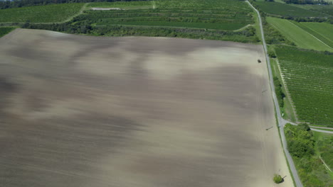 Vast-farming-field-in-moravian-landscape-in-Czechia,-drone-shot