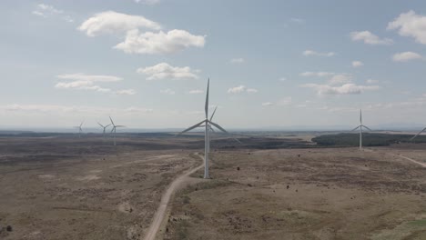 Moving-Aerial-Shot-Of-Multiple-Wind-Turbines-On-A-Windfarm,-Scotland