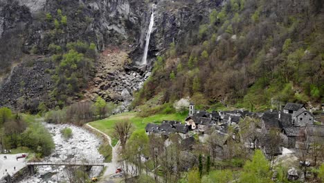 Luftüberführung-über-Dem-Dorf-Foroglio-Im-Tessin,-Schweiz-Mit-Blick-Auf-Einen-Der-Grössten-Wasserfälle-Der-Schweizer-Alpen-Im-Hintergrund-Alter-Steinhäuser