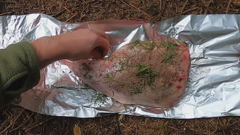 Oil,-spices,-and-rosemary-rubbed-onto-leg-of-lamb-for-campfire-foil