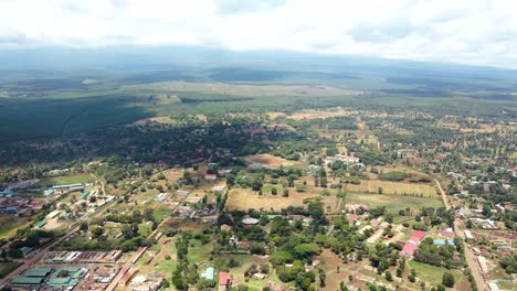 Aerial-drone-view-Open-Air-market-in-the-Loitokitok-town,-Kenya-and-mount-Kilimanjaro--Rural-village-of-Kenya