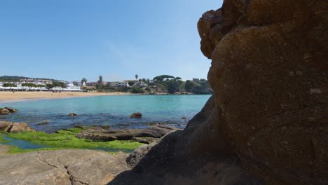 La-Fosca-beach-in-Girona-Mediterranean-sea-without-people-paradisiacal-blue-turquoise-blue-sky-rock-in-the-foreground