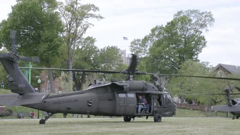 Blackhawk-helicopter-on-the-ground-with-it's-rotors-spinning,-ready-for-takeoff