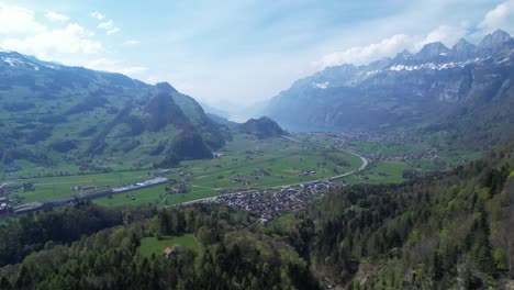 Beautiful-Swiss-town-of-Walenstadt-in-Switzerland,-Europe,-aerial-view-of-valley-surrounded-by-Swiss-Alps