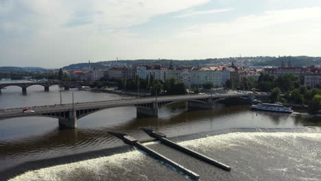Prague-Jirásek-bridge-over-Vltava-river-with-weir-and-sluice,-drone