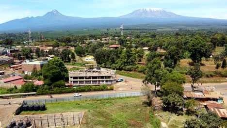 Aerial-drone-view-Open-Air-market-in-the-Loitokitok-town,-Kenya-and-mount-Kilimanjaro--Rural-village-of-Kenya